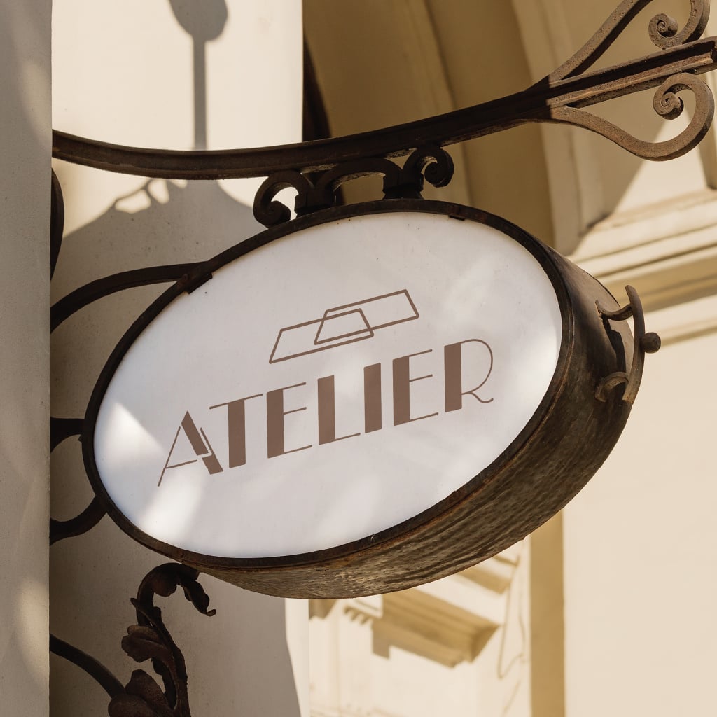 atelier-shop-sign-mockup Atelier shop sign mockup showing an overhanging exterior signage design